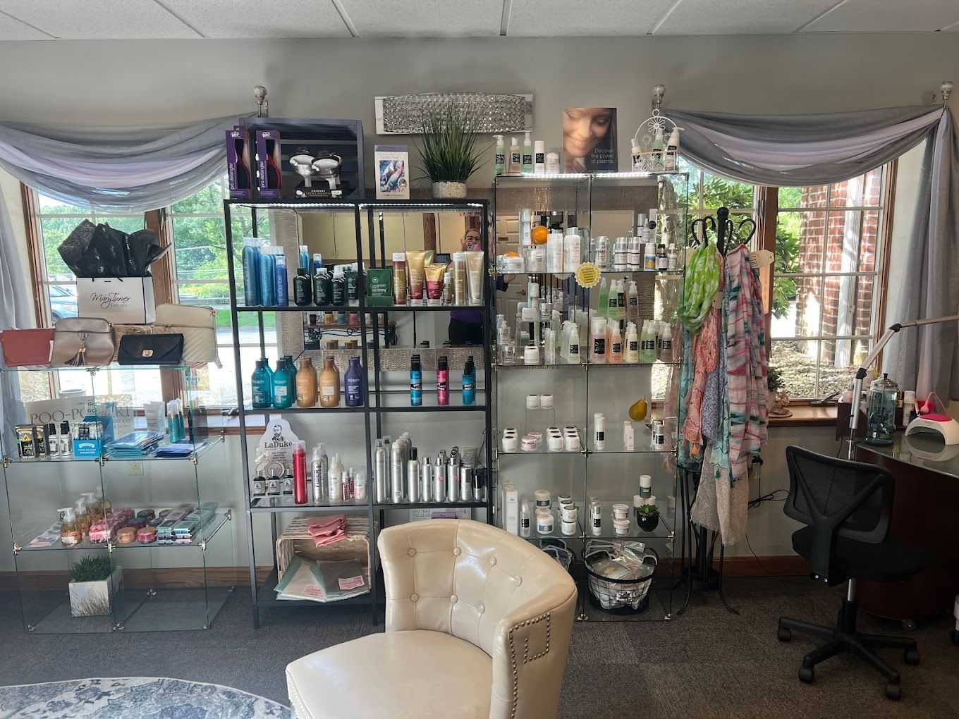 Beauty salon with shelves displaying various hair and skincare products, accessories, and scarves.