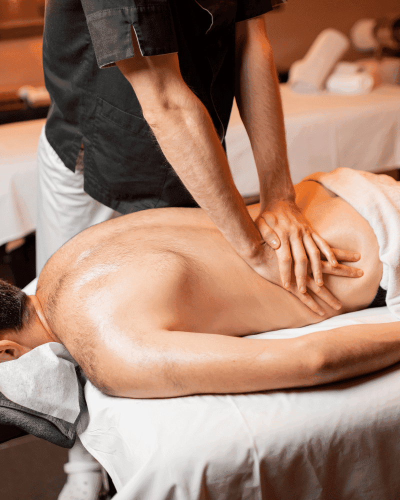 Person receiving a back massage in a spa setting, highlighting relaxation and wellness.